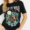 Women in a keep it wild graphic tee with hand in her pocket