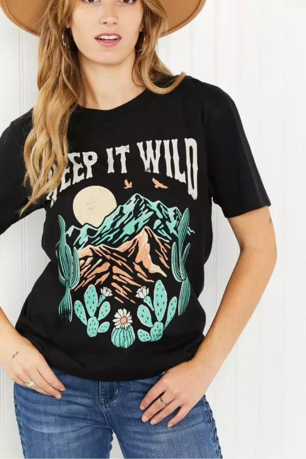 Women in a keep it wild graphic tee with hand in her pocket